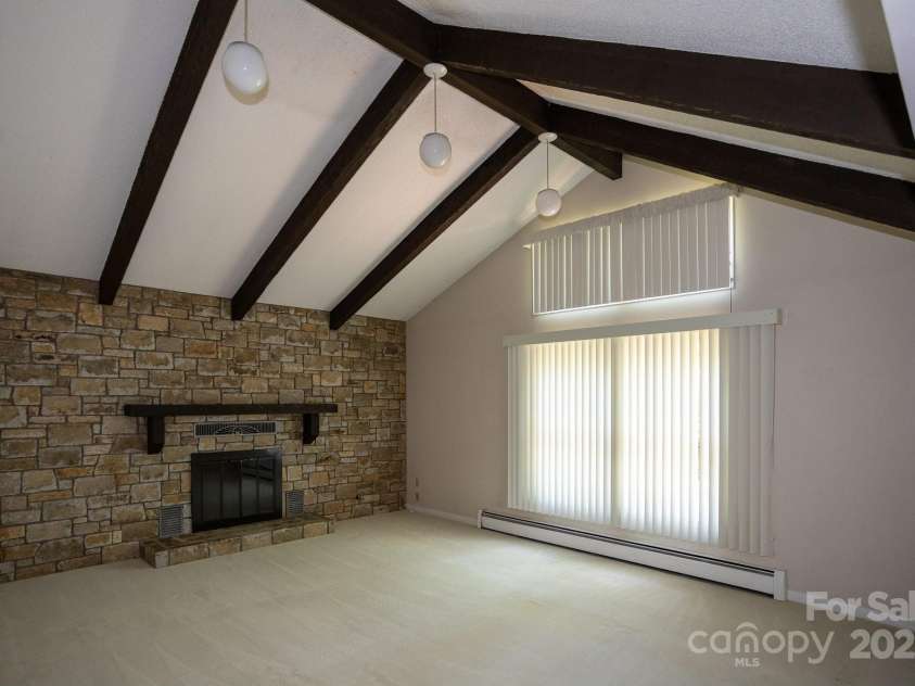 15 Cedar Trail, Asheville, NC 28803.  MLS# CAR4270530, YatesRealty ID 21431. Soaring ceiling comfort den.  Fireplace for warm relaxing evening