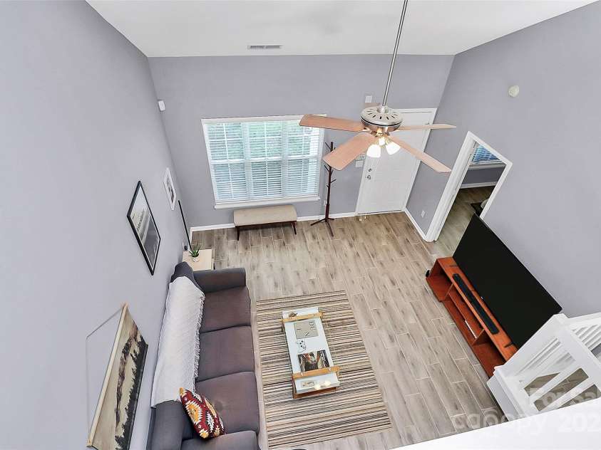 5980 Cougar Lane, Charlotte, NC 28269.  MLS# CAR4272520, YatesRealty ID 21432. View of living room from loft area.