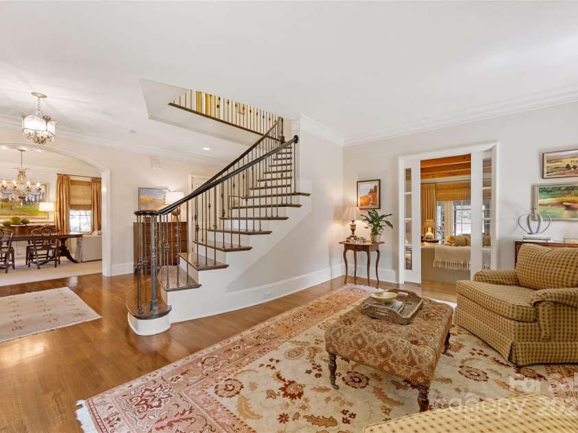 1728 Shadow Forest Drive, Matthews, NC 28105.  MLS# CAR4268214, YatesRealty ID 21441. The formal living room has a French door entry into the family room.