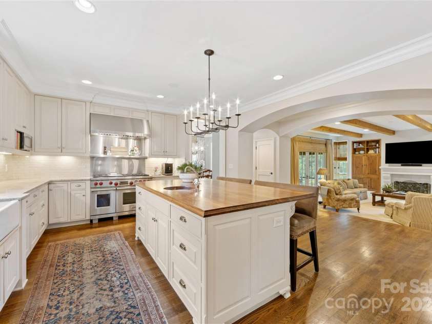 1728 Shadow Forest Drive, Matthews, NC 28105.  MLS# CAR4268214, YatesRealty ID 21441. Wow! What a kitchen! Stunning inset cabinetry, granite countertops, tile backsplash, & fabulous lighting.
