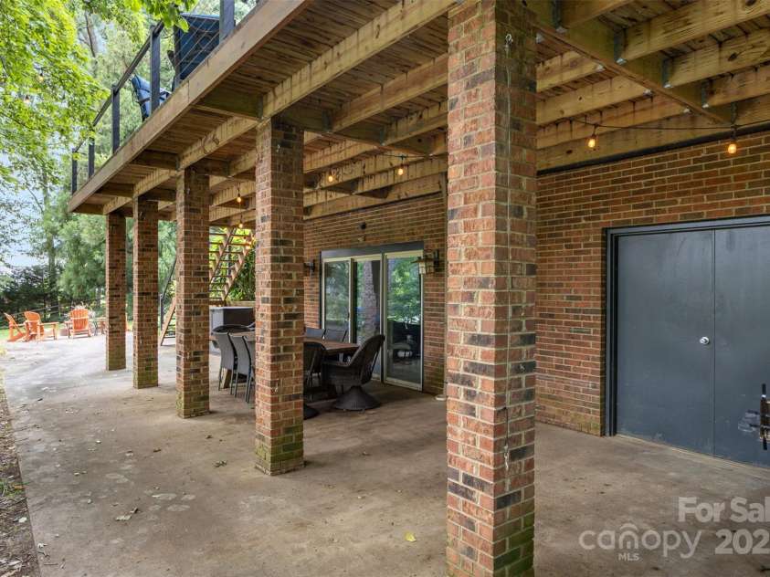3004 Vernell Lane, Shelby, NC 28150.  MLS# CAR4238720, YatesRealty ID 21447. Basement level outdoor area w/ cafe lights, storage closet w/ crawlspace access