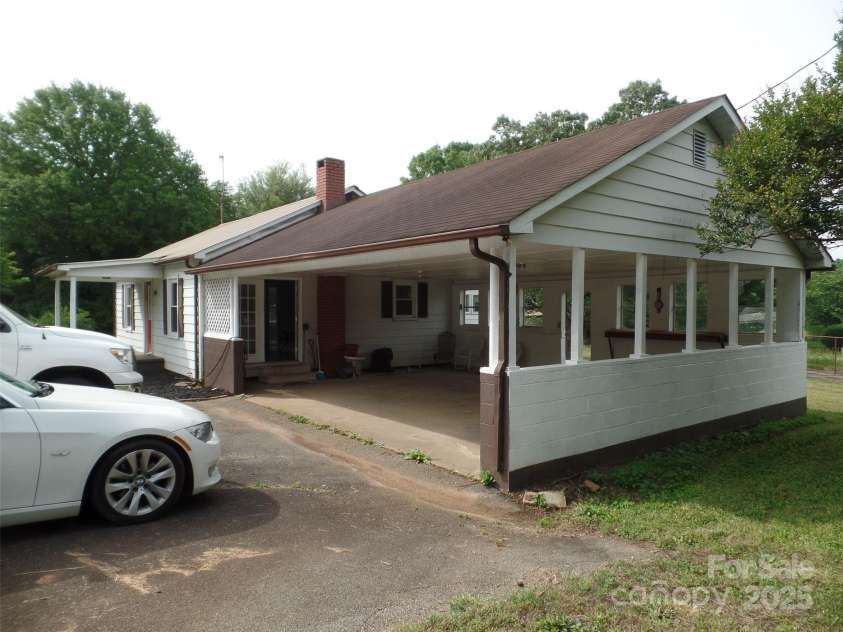5004 King Wilkinson Road, Denver, NC 28037.  MLS# CAR4259996, YatesRealty ID 21460. Side view of large carport