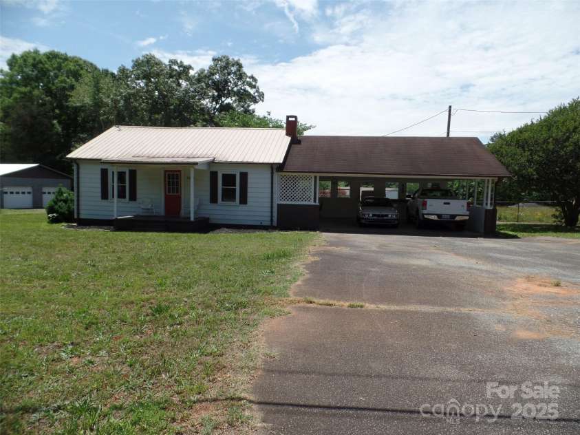 5004 King Wilkinson Road, Denver, NC 28037.  MLS# CAR4259996, YatesRealty ID 21460. Two Car Carport with sitting Area.