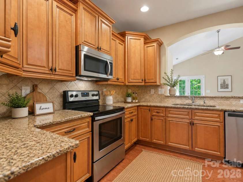 144 Hawks Landing Drive, Troutman, NC 28166.  MLS# CAR4367521, YatesRealty ID 21463. Virtually staged with decor  in kitchen