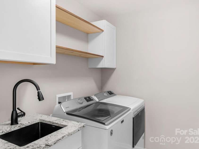 3701 Methodist Church Lane, Waxhaw, NC 28173.  MLS# CAR4270658, YatesRealty ID 21466. Laundry room with sink and storage on the upper level