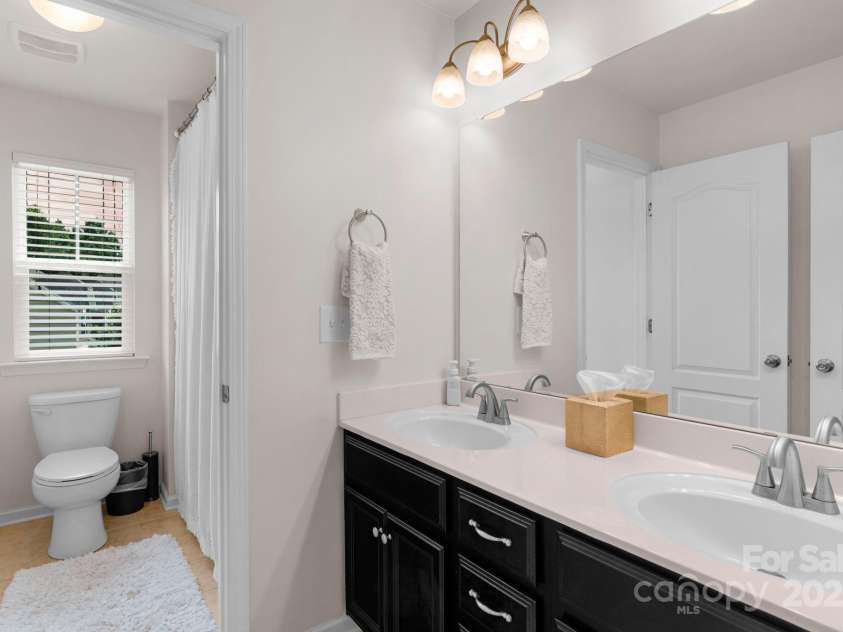3701 Methodist Church Lane, Waxhaw, NC 28173.  MLS# CAR4270658, YatesRealty ID 21466. Secondary bathroom with double sink vanity and separate shower/water closet