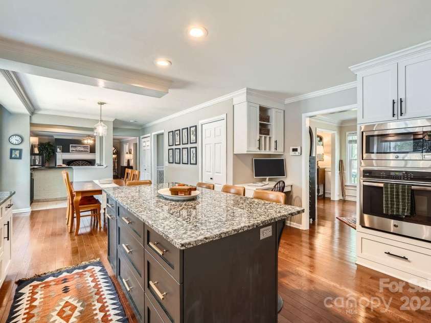 1175 18th Avenue, Hickory, NC 28601.  MLS# CAR4267840, YatesRealty ID 21483. A built-in workstation and wall ovens add everyday convenience, and the pantry ensures everything is within reach. Whether hosting guests or preparing a quiet meal, this kitchen delivers modern efficiency in a timeless pack