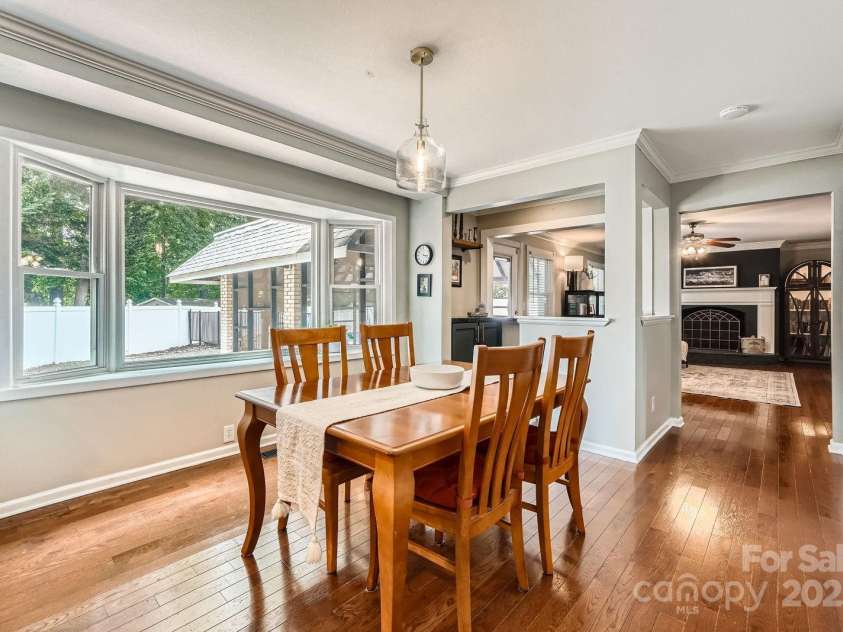 1175 18th Avenue, Hickory, NC 28601.  MLS# CAR4267840, YatesRealty ID 21483. Enjoy everyday dining in this inviting breakfast area, filled with natural light from an oversized picture window that frames tranquil backyard views. Crown molding and hardwood flooring add a polished touch, while the open