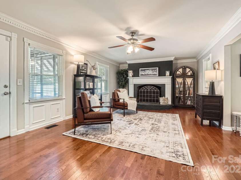 1175 18th Avenue, Hickory, NC 28601.  MLS# CAR4267840, YatesRealty ID 21483. Expansive Great Room with Statement Fireplace. This spacious great room offers the perfect blend of warmth and sophistication, featuring rich wood flooring, crisp crown molding, and abundant natural light from multiple wind