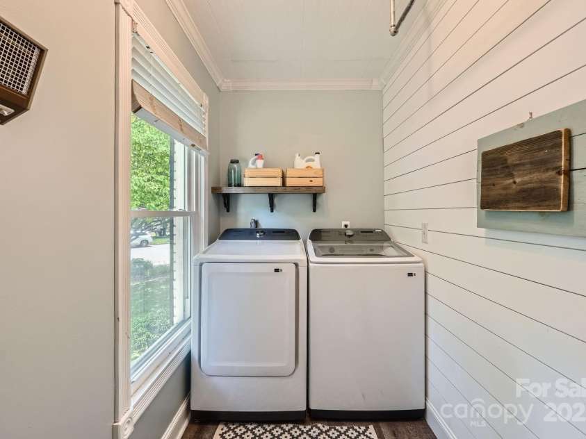 1175 18th Avenue, Hickory, NC 28601.  MLS# CAR4267840, YatesRealty ID 21483. Main Floor Laundry Room with Natural Light. Conveniently located on the main floor, this dedicated laundry room offers both charm and functionality. A large window fills the space with natural light, while the shiplap accen