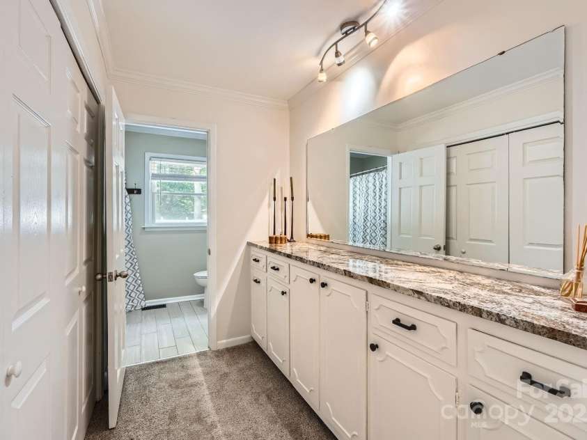 1175 18th Avenue, Hickory, NC 28601.  MLS# CAR4267840, YatesRealty ID 21483. The en-suite bathroom features an extended granite-topped dual vanity with generous storage, updated fixtures. Ample closet space provides convenience and function.