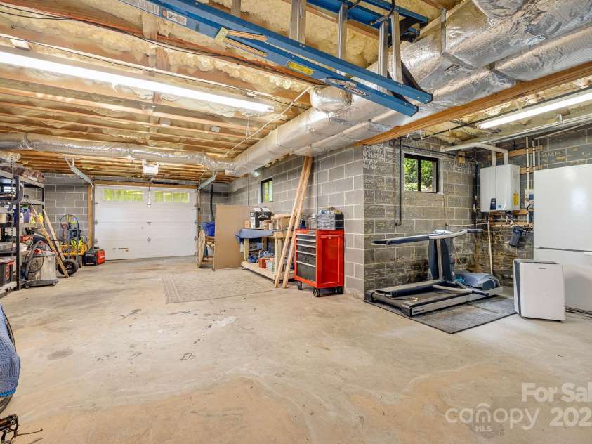 90 Reed Road, Asheville, NC 28805.  MLS# CAR4271385, YatesRealty ID 21485. Garage/ Basement has Room for Workshop and Storage