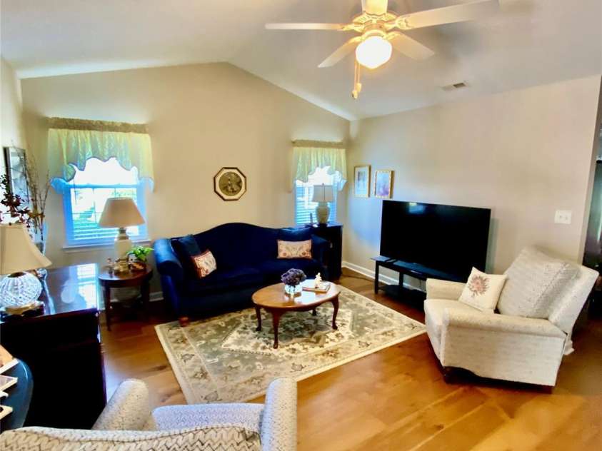 101 Keswick Lane, Mooresville, NC 28117.  MLS# CAR4317962, YatesRealty ID 21518. Living Room with ceiling fan/light fixture and engineered hardwoods, from foyer area view.
