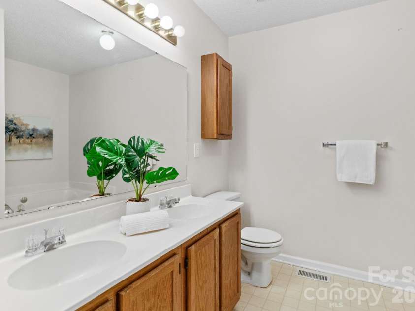 300 Armour Street, Davidson, NC 28036.  MLS# CAR4374388, YatesRealty ID 21526. Primary bath features dual sinks and spa tub and ample floor space.