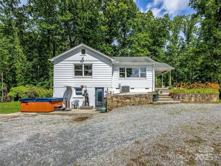170 Twin Springs Road, Hendersonville, NC 28792.  MLS# CAR4273179, YatesRealty ID 21536. Hot tub patio and exterior lower level entrance