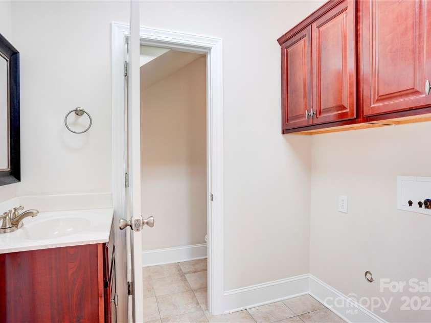 216 Harrison Lane, Locust, NC 28097.  MLS# CAR4244382, YatesRealty ID 21537. Laundry room showing 1/2 bath
