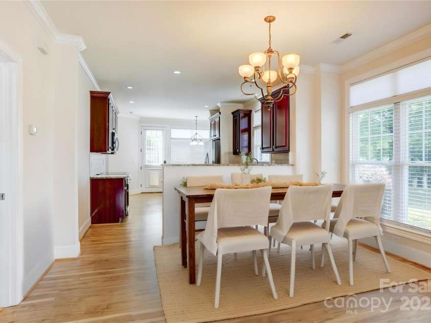 216 Harrison Lane, Locust, NC 28097.  MLS# CAR4244382, YatesRealty ID 21537. Looking into kitchen with furniture