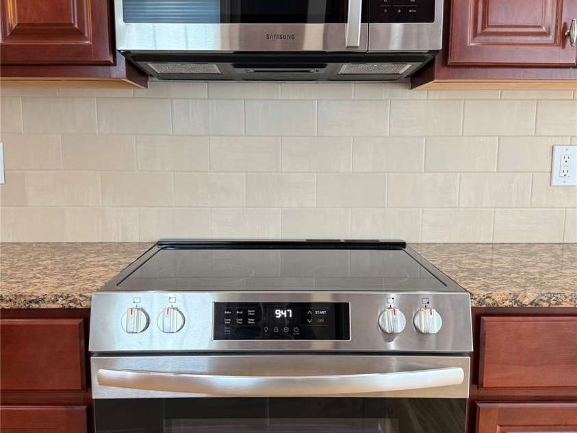 216 Harrison Lane, Locust, NC 28097.  MLS# CAR4244382, YatesRealty ID 21537. New stove with microwave above