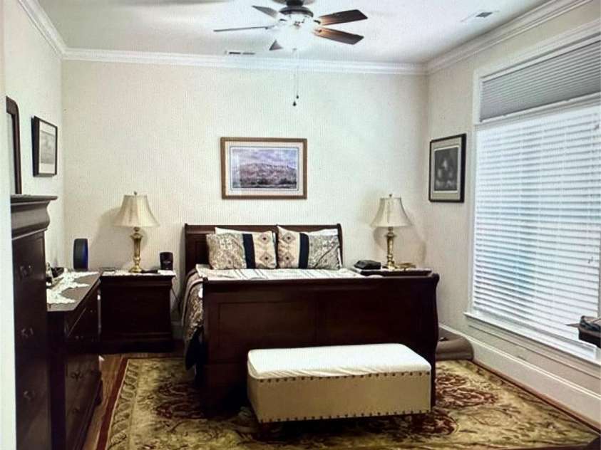 216 Harrison Lane, Locust, NC 28097.  MLS# CAR4244382, YatesRealty ID 21537. Primary suite on main level shown w/ furniture