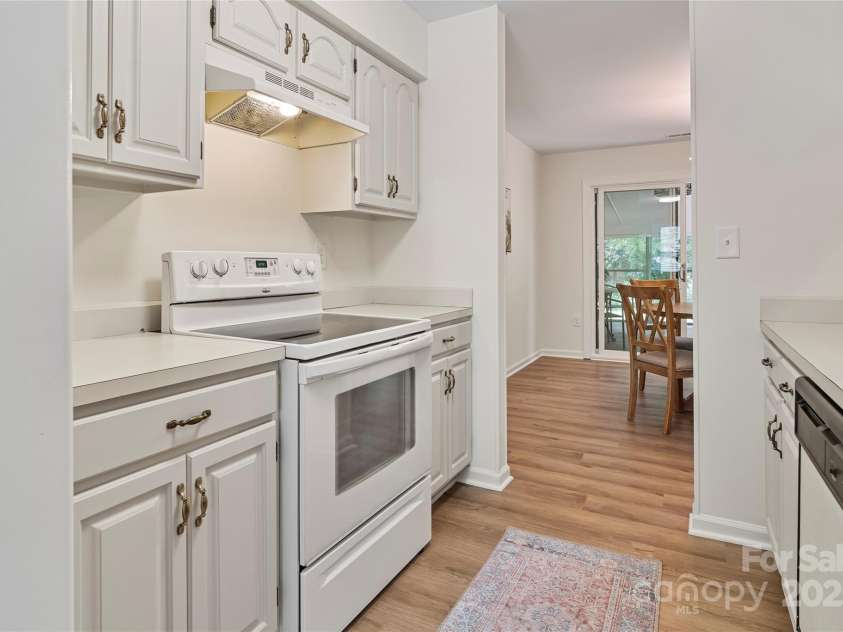 407 Sweetgum Drive, Fort Mill, SC 29715.  MLS# CAR4272607, YatesRealty ID 21552. View of the dining area & screened in porch from kitchen