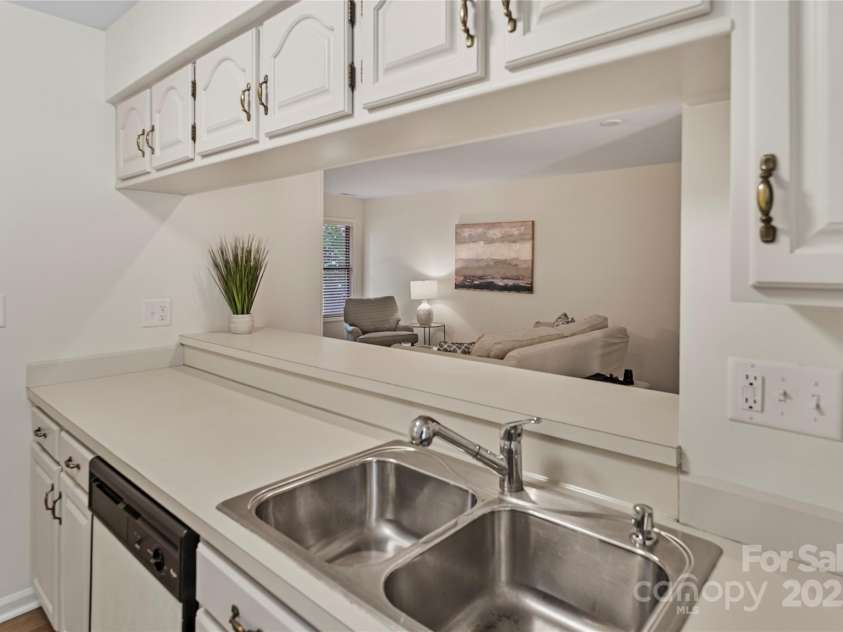 407 Sweetgum Drive, Fort Mill, SC 29715.  MLS# CAR4272607, YatesRealty ID 21552. View of the living room through the kitchen
