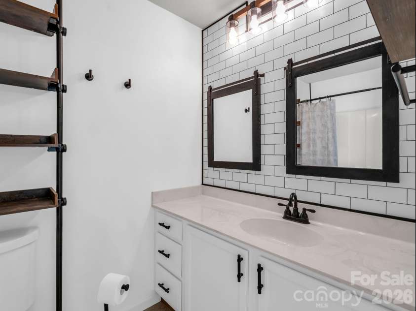 64 Lanceford Circle, Fletcher, NC 28732.  MLS# CAR4374412, YatesRealty ID 21576. Primary bath with storage shelves