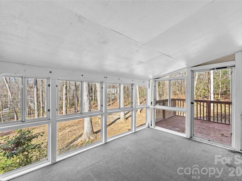 213 Woodrun Drive, Mount Gilead, NC 27306.  MLS# CAR4334949, YatesRealty ID 2158. Bright sunroom offers the perfect spot for morning coffee, quiet reading, or unwinding after a day on the lake.