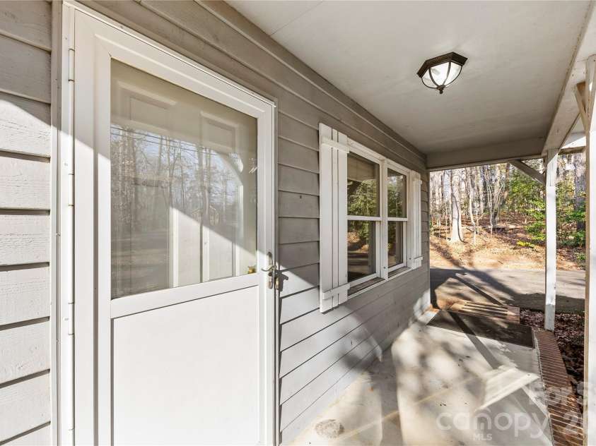 213 Woodrun Drive, Mount Gilead, NC 27306.  MLS# CAR4334949, YatesRealty ID 2158. Charming front porch offers a welcoming spot to enjoy morning coffee and quiet lake mornings.
