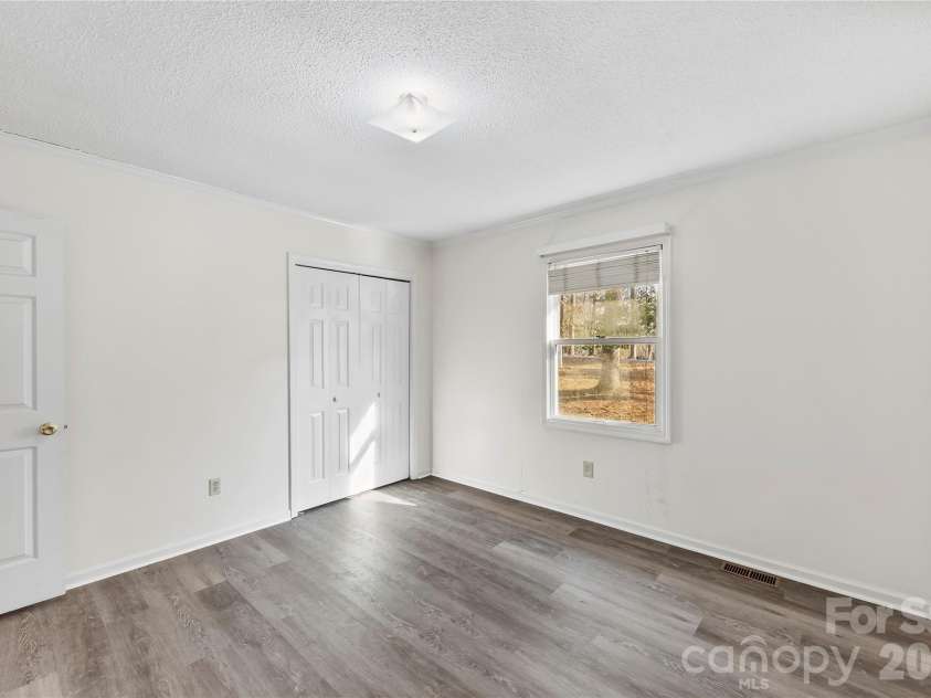 213 Woodrun Drive, Mount Gilead, NC 27306.  MLS# CAR4334949, YatesRealty ID 2158. Comfortable guest bedrooms create a welcoming place for visitors to relax after full days on the lake.