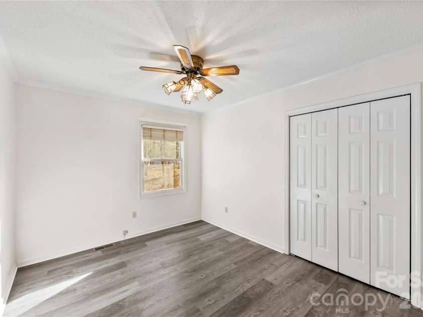 213 Woodrun Drive, Mount Gilead, NC 27306.  MLS# CAR4334949, YatesRealty ID 2158. Cozy guest bedrooms provide the perfect retreat for visitors enjoying time at the lake.