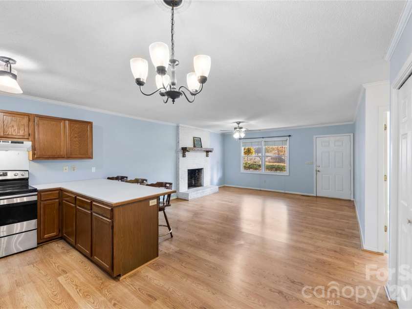 213 Woodrun Drive, Mount Gilead, NC 27306.  MLS# CAR4334949, YatesRealty ID 2158. Open living and kitchen space sets the tone for lake days — easy flow for post-dock dinners, casual gatherings, and relaxed evenings in.