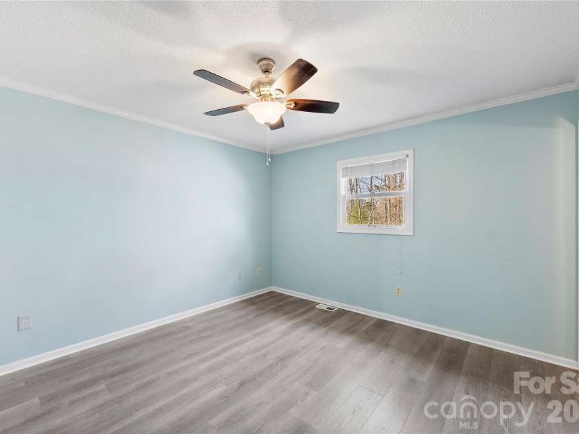 213 Woodrun Drive, Mount Gilead, NC 27306.  MLS# CAR4334949, YatesRealty ID 2158. Primary bedroom provides comfort and privacy with its own ensuite bath and two closets, making weekend stays feel effortless.