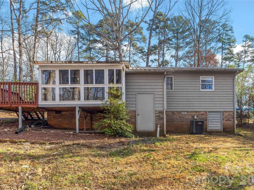 213 Woodrun Drive, Mount Gilead, NC 27306.  MLS# CAR4334949, YatesRealty ID 2158. Rear exterior offers a peaceful backdrop for outdoor living, perfect for unwinding after a day on the lake.