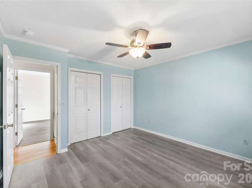 213 Woodrun Drive, Mount Gilead, NC 27306.  MLS# CAR4334949, YatesRealty ID 2158. Spacious primary bedroom features a private ensuite bath and dual closets — ideal for winding down after full days at the lake.