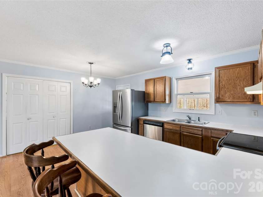 213 Woodrun Drive, Mount Gilead, NC 27306.  MLS# CAR4334949, YatesRealty ID 2158. The heart of the home features an open living and kitchen design that makes lake life feel simple, social, and stress-free.