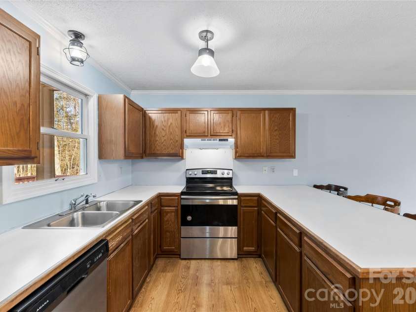 213 Woodrun Drive, Mount Gilead, NC 27306.  MLS# CAR4334949, YatesRealty ID 2158. The heart of the home features an open living and kitchen design that makes lake life feel simple, social, and stress-free.