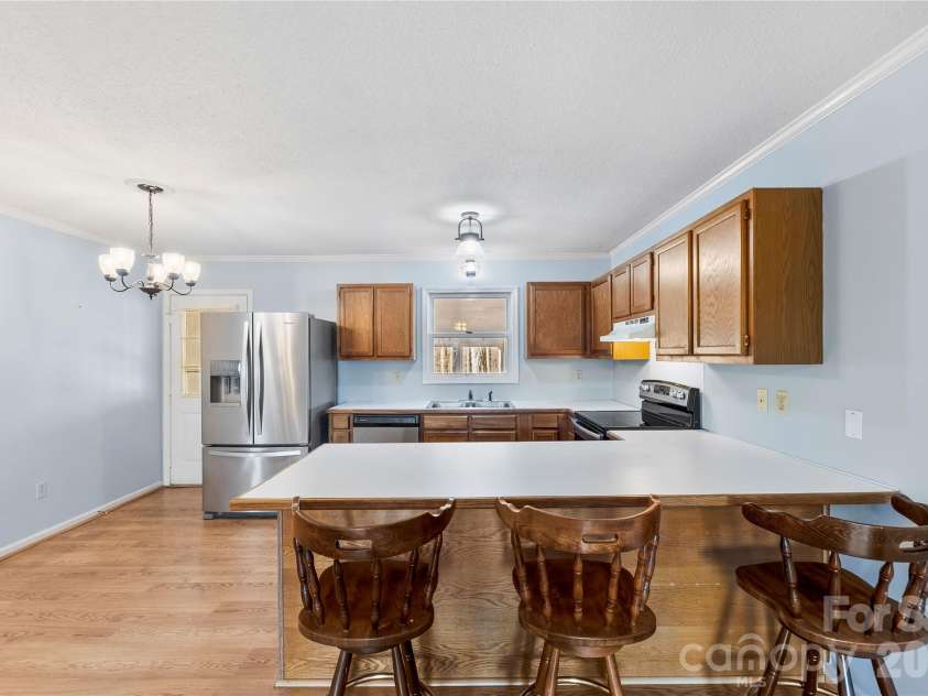 213 Woodrun Drive, Mount Gilead, NC 27306.  MLS# CAR4334949, YatesRealty ID 2158. The heart of the home features an open living and kitchen design that makes lake life feel simple, social, and stress-free.