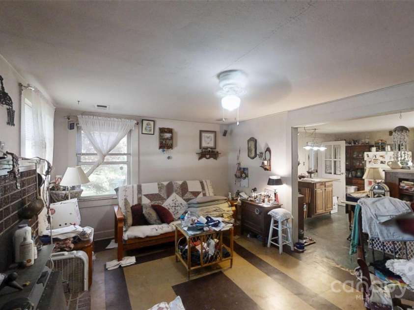 21 Maple Avenue, Candler, NC 28715.  MLS# CAR4273168, YatesRealty ID 21580. Living room towards kitchen