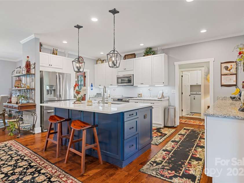 156 Olivet Lane, Fletcher, NC 28732.  MLS# CAR4272204, YatesRealty ID 21590. Kitchen with numerous cabinets, work area with granite countertops