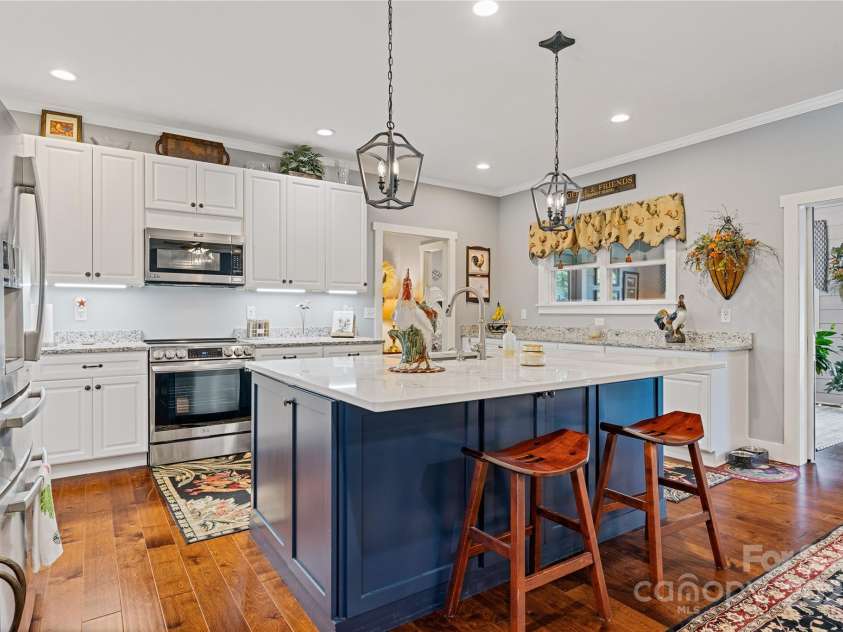 156 Olivet Lane, Fletcher, NC 28732.  MLS# CAR4272204, YatesRealty ID 21590. Looking towards the kitchen and seeing the seating area on the island.