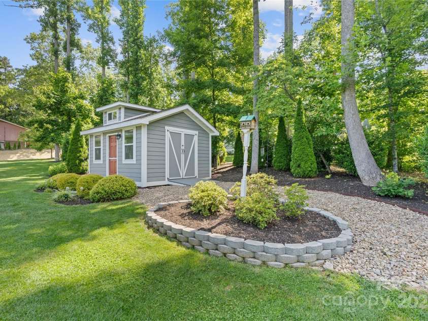 156 Olivet Lane, Fletcher, NC 28732.  MLS# CAR4272204, YatesRealty ID 21590. Showing double door entry into shed & raised flower beds.