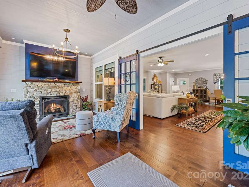 156 Olivet Lane, Fletcher, NC 28732.  MLS# CAR4272204, YatesRealty ID 21590. View 1 of the all season sunroom showing the barn style double beveled glass french doors towards Great room