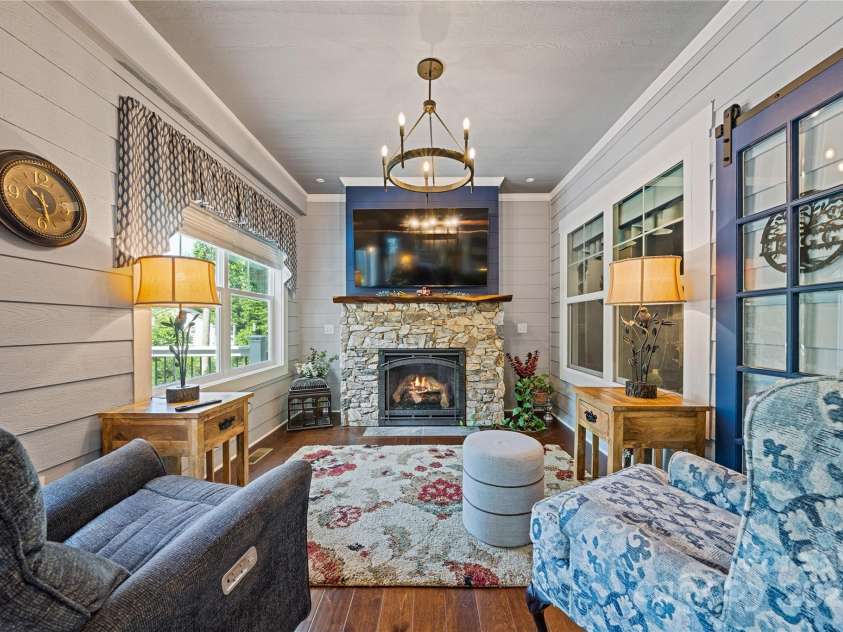 156 Olivet Lane, Fletcher, NC 28732.  MLS# CAR4272204, YatesRealty ID 21590. View 2 of sunroom showing the stone faced gas vented fireplace