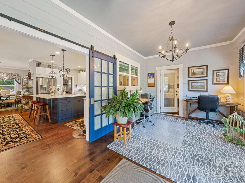 156 Olivet Lane, Fletcher, NC 28732.  MLS# CAR4272204, YatesRealty ID 21590. View 3 of the sunroom showing office space if desired and looking toward the kitchen.