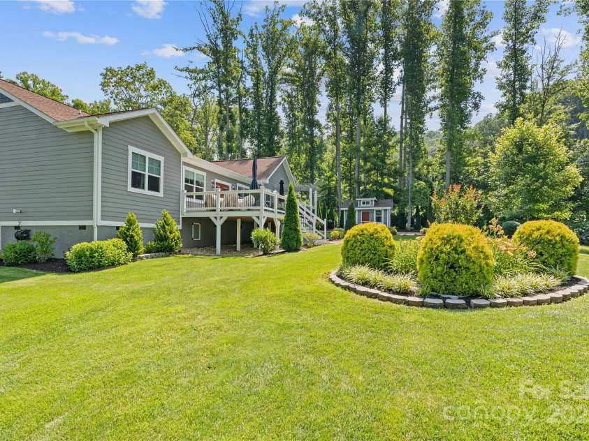 156 Olivet Lane, Fletcher, NC 28732.  MLS# CAR4272204, YatesRealty ID 21590. View of a portion of the landscaped back yard