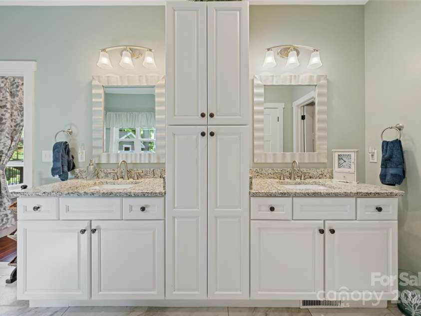 156 Olivet Lane, Fletcher, NC 28732.  MLS# CAR4272204, YatesRealty ID 21590. View of the wonderful double sink vanities with storage seperated by the center cabinet