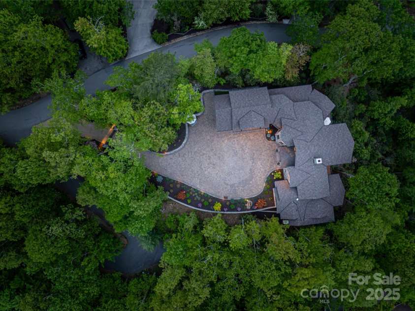 511 Asgi Trail, Maggie Valley, NC 28751.  MLS# CAR4258504, YatesRealty ID 21595. Birds eye view at night shows the masterful roof line and incredible lighting