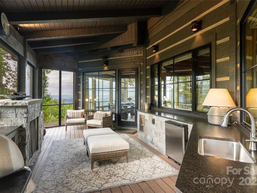 511 Asgi Trail, Maggie Valley, NC 28751.  MLS# CAR4258504, YatesRealty ID 21595. Outdoor Summer kitchen with automatic electric screens