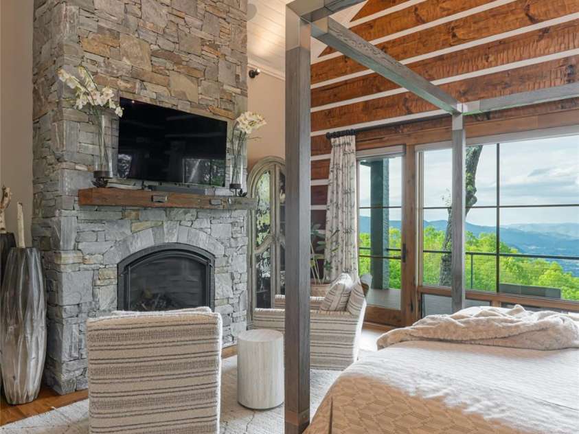 511 Asgi Trail, Maggie Valley, NC 28751.  MLS# CAR4258504, YatesRealty ID 21595. Primary Suite with floor to ceiling stone fireplace
