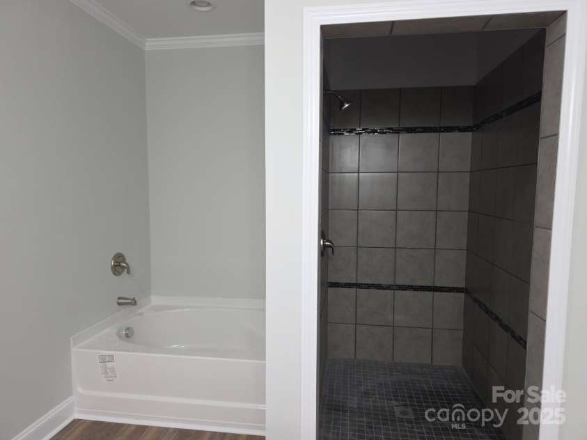 2573 Hwy 151 Highway, Pageland, SC 29728.  MLS# CAR4256594, YatesRealty ID 21615. Ensuite bathroom with soaking tub and ceramic tiled shower